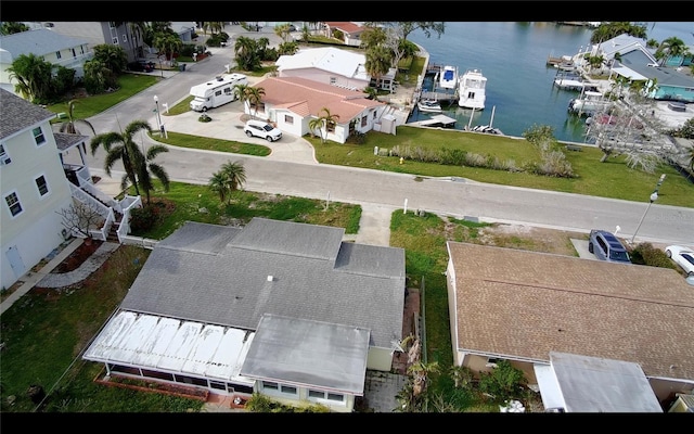 birds eye view of property featuring a water view and a residential view