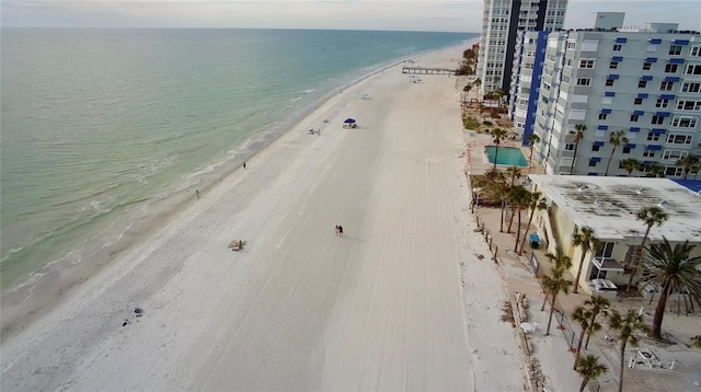 drone / aerial view with a beach view and a water view