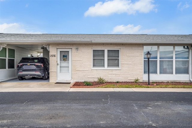 property entrance featuring a carport