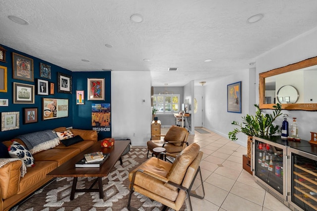 tiled living room with indoor bar, a chandelier, wine cooler, and a textured ceiling