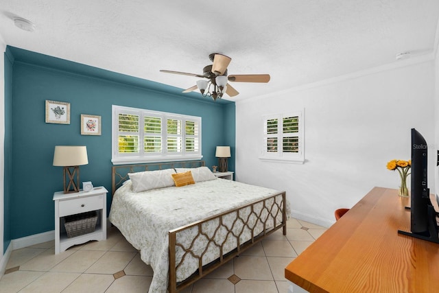 bedroom with ornamental molding, light tile patterned floors, ceiling fan, and a textured ceiling