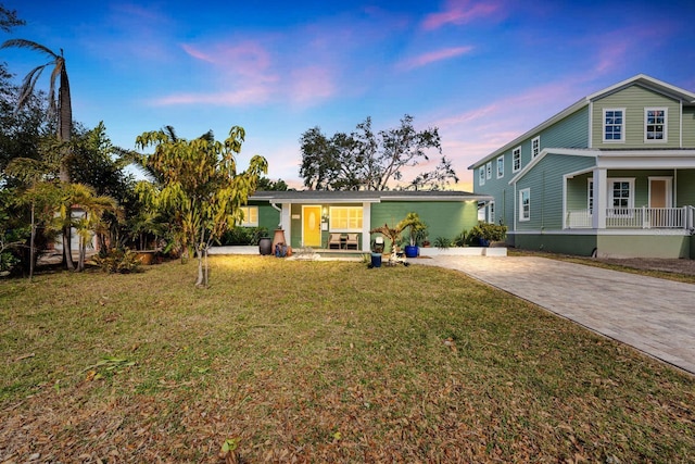 view of front facade with a porch and a lawn