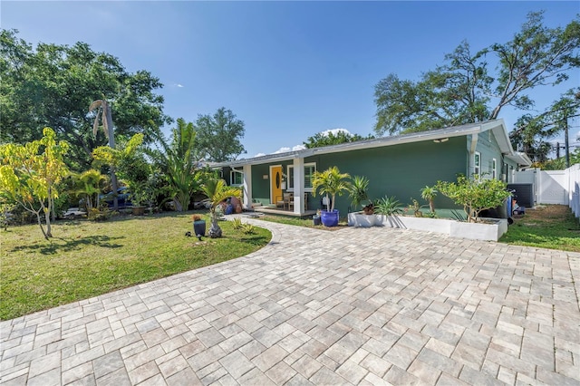 view of front of property featuring a porch, fence, a front lawn, and a gate