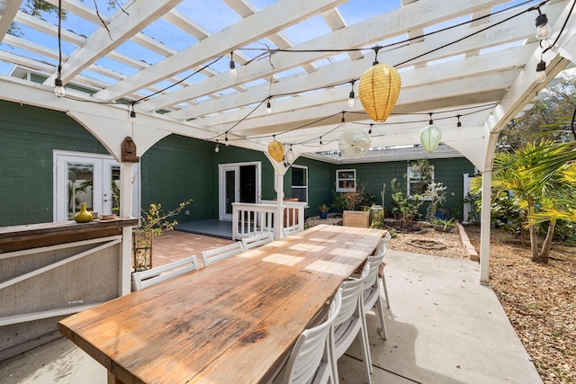 view of patio / terrace featuring french doors, outdoor dining space, and a pergola
