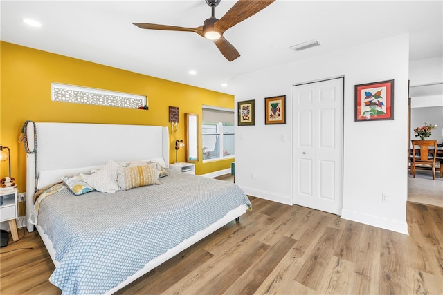 bedroom featuring wood finished floors, baseboards, visible vents, and recessed lighting