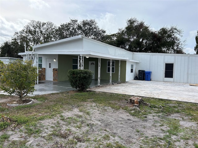 back of house with a patio