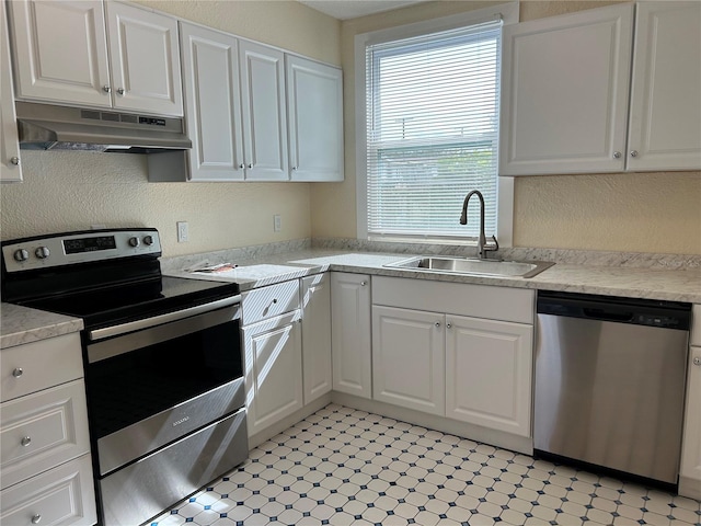 kitchen featuring stainless steel appliances, sink, and white cabinets