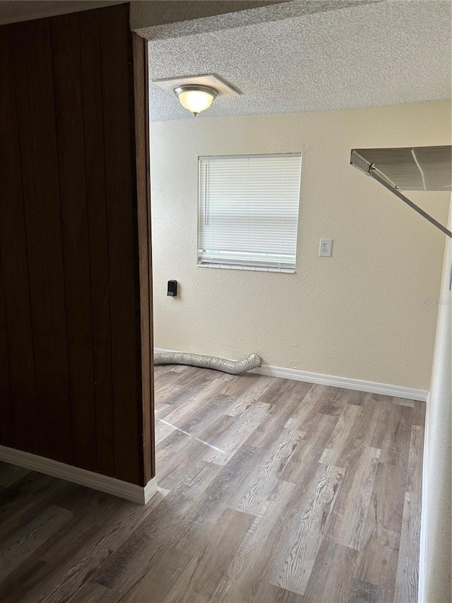 clothes washing area featuring hardwood / wood-style floors