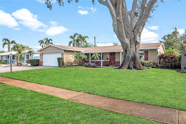 ranch-style house featuring a garage and a front yard