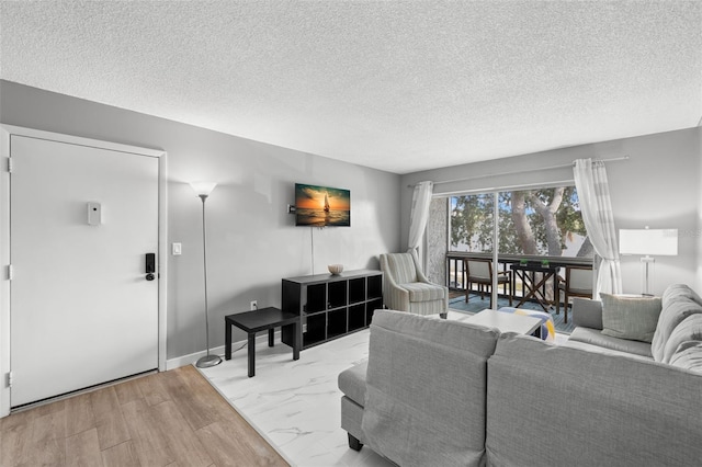 living room with a textured ceiling and light wood-type flooring