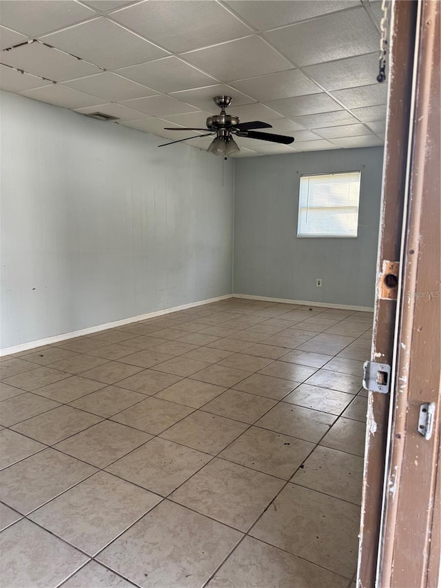 spare room featuring light tile patterned flooring, ceiling fan, and a paneled ceiling