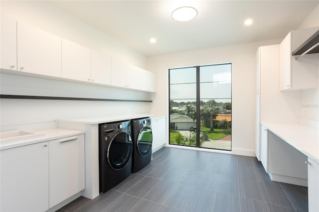 laundry area with cabinets and independent washer and dryer