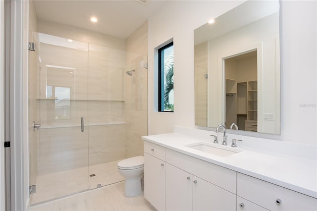 bathroom with vanity, toilet, and walk in shower