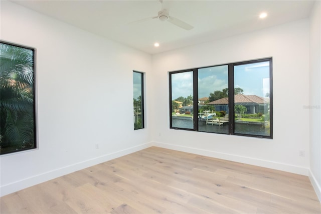 unfurnished room with ceiling fan and light wood-type flooring