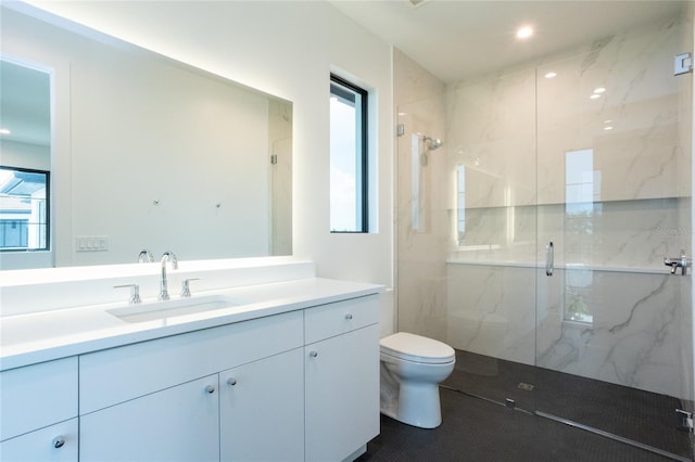 bathroom featuring an enclosed shower, vanity, and toilet