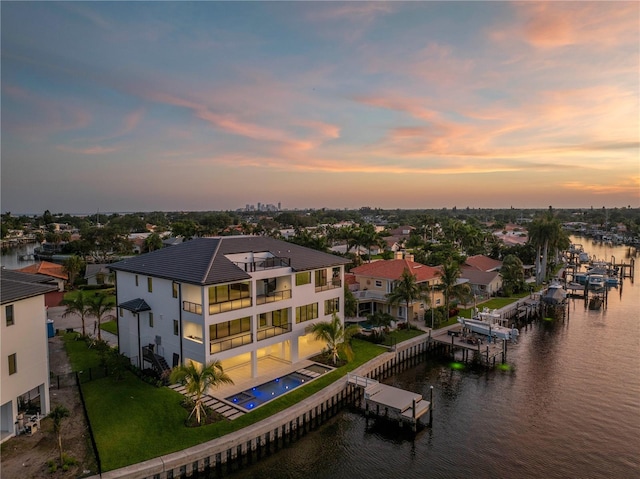 aerial view at dusk with a water view