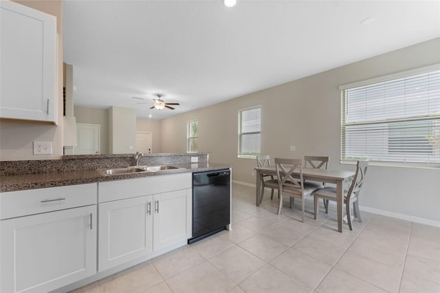 kitchen with white cabinets, light tile patterned floors, sink, and black dishwasher