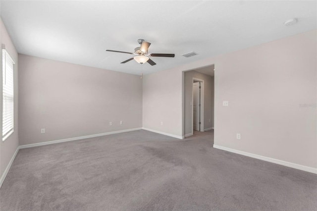 unfurnished room featuring ceiling fan and carpet