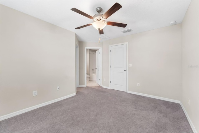 carpeted spare room with ceiling fan