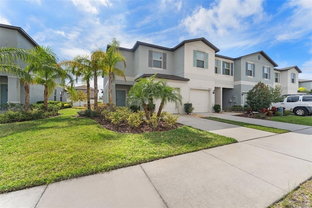 view of property featuring a garage and a front yard