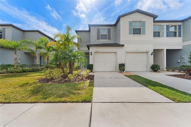 view of property featuring a garage and a front yard