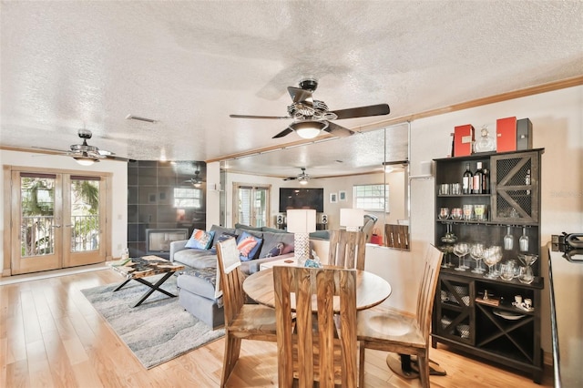 dining space featuring a fireplace, a wealth of natural light, and light wood-type flooring