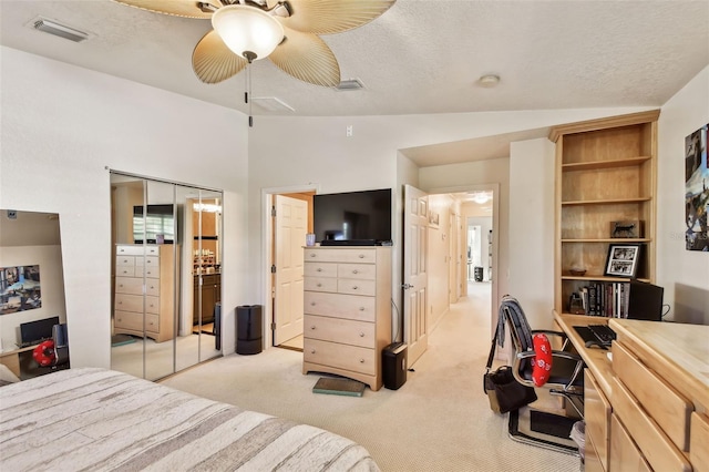 bedroom featuring lofted ceiling, light carpet, and a textured ceiling