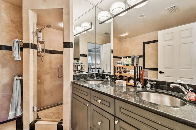 bathroom with vanity, tile walls, and walk in shower