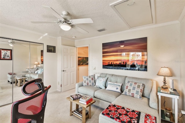 living room featuring crown molding, light colored carpet, ceiling fan, and a textured ceiling