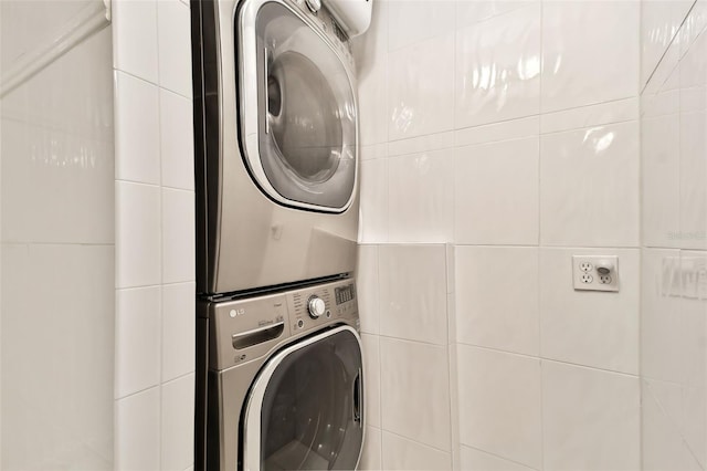 laundry room featuring stacked washer and clothes dryer