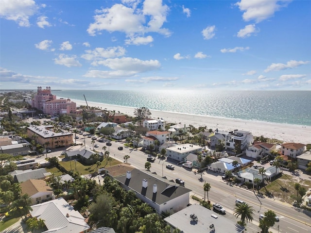 drone / aerial view featuring a water view and a view of the beach