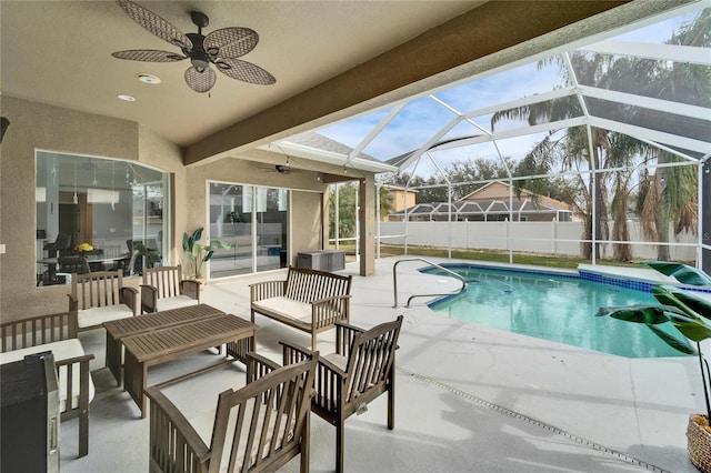 view of swimming pool featuring a fenced in pool, glass enclosure, ceiling fan, fence, and a patio area