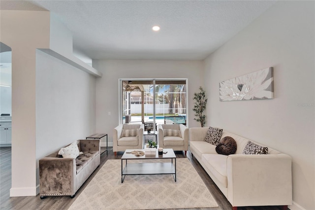 living room with hardwood / wood-style floors and a textured ceiling