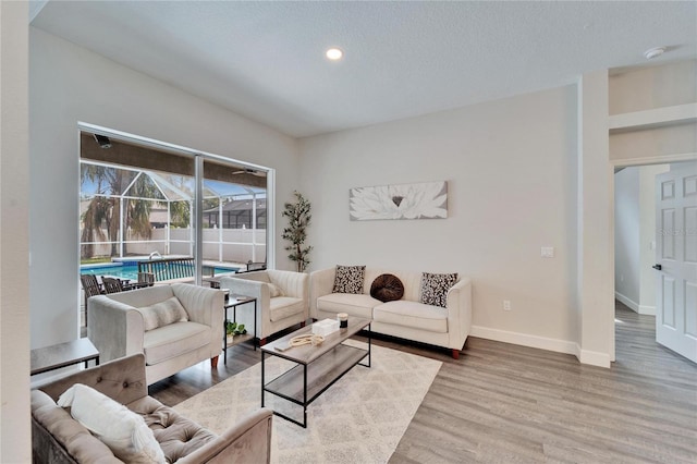 living room featuring hardwood / wood-style flooring and a textured ceiling