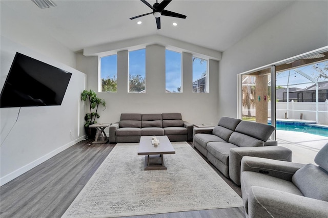 living room featuring ceiling fan, hardwood / wood-style floors, and a wealth of natural light