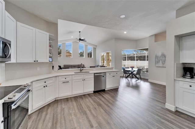 kitchen featuring stainless steel appliances, white cabinetry, a healthy amount of sunlight, and sink