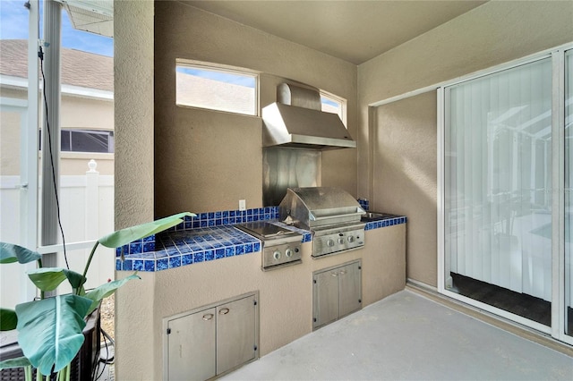 view of patio with area for grilling and a grill