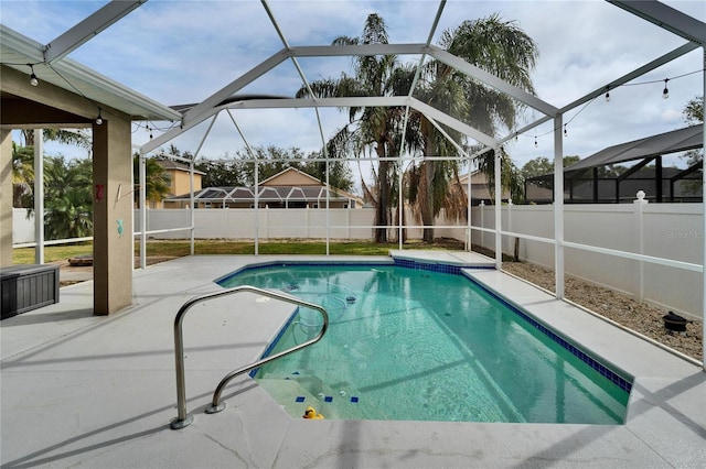 view of pool featuring a patio area and glass enclosure