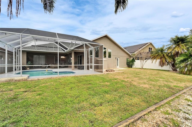 back of property with a yard, a lanai, and a patio area