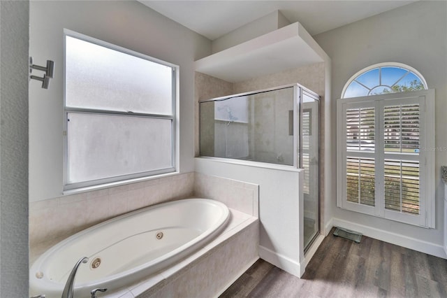 bathroom featuring separate shower and tub and hardwood / wood-style floors