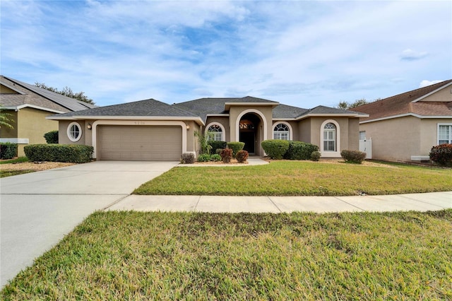 ranch-style home featuring a garage and a front yard