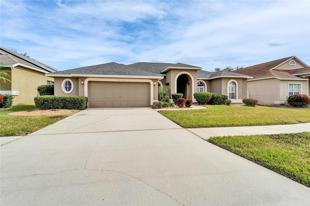 single story home with a garage and a front lawn