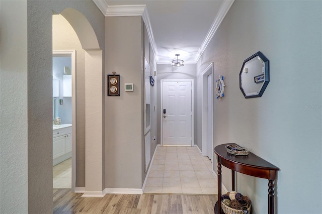 hall featuring ornamental molding and light hardwood / wood-style flooring