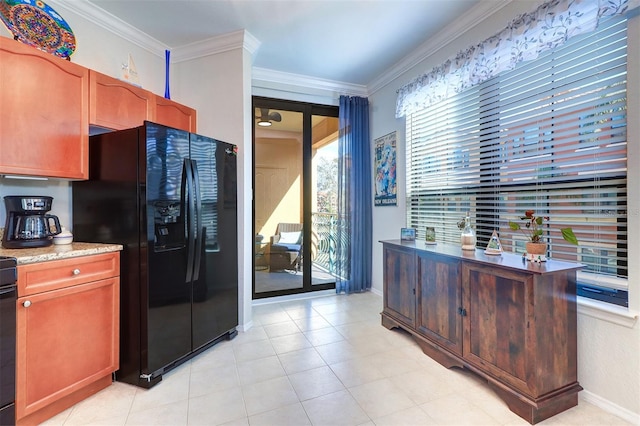 kitchen featuring ornamental molding and black fridge