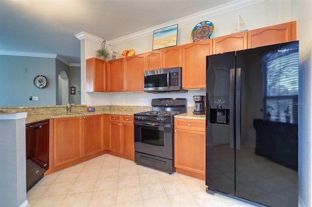 kitchen with light stone countertops, crown molding, black appliances, and sink