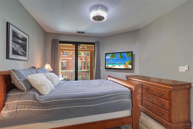 bedroom featuring access to exterior and light wood-type flooring