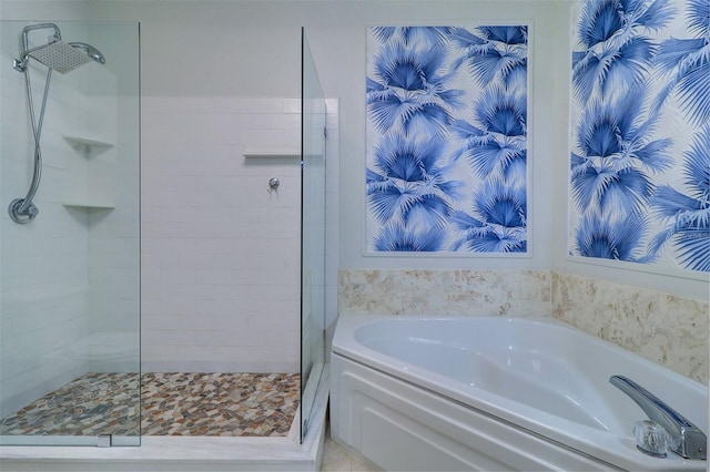 bathroom featuring shower with separate bathtub