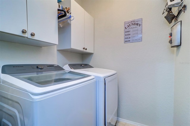 washroom with independent washer and dryer and cabinets