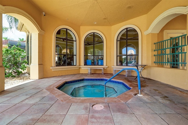 view of swimming pool featuring an in ground hot tub and a patio