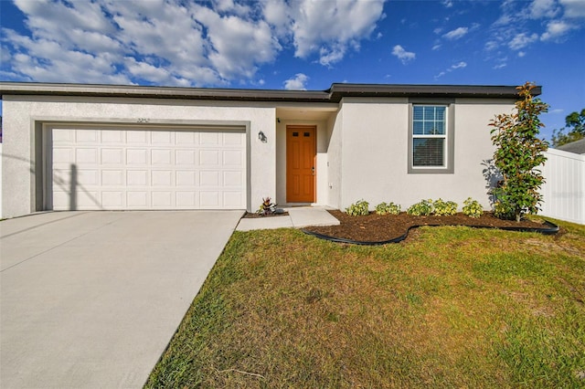 view of front of house featuring a garage and a front lawn